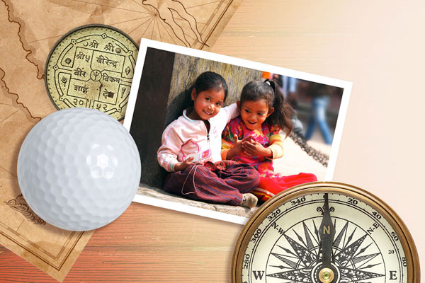 nepali girls charity objects on table currency of nepal map and golf ball